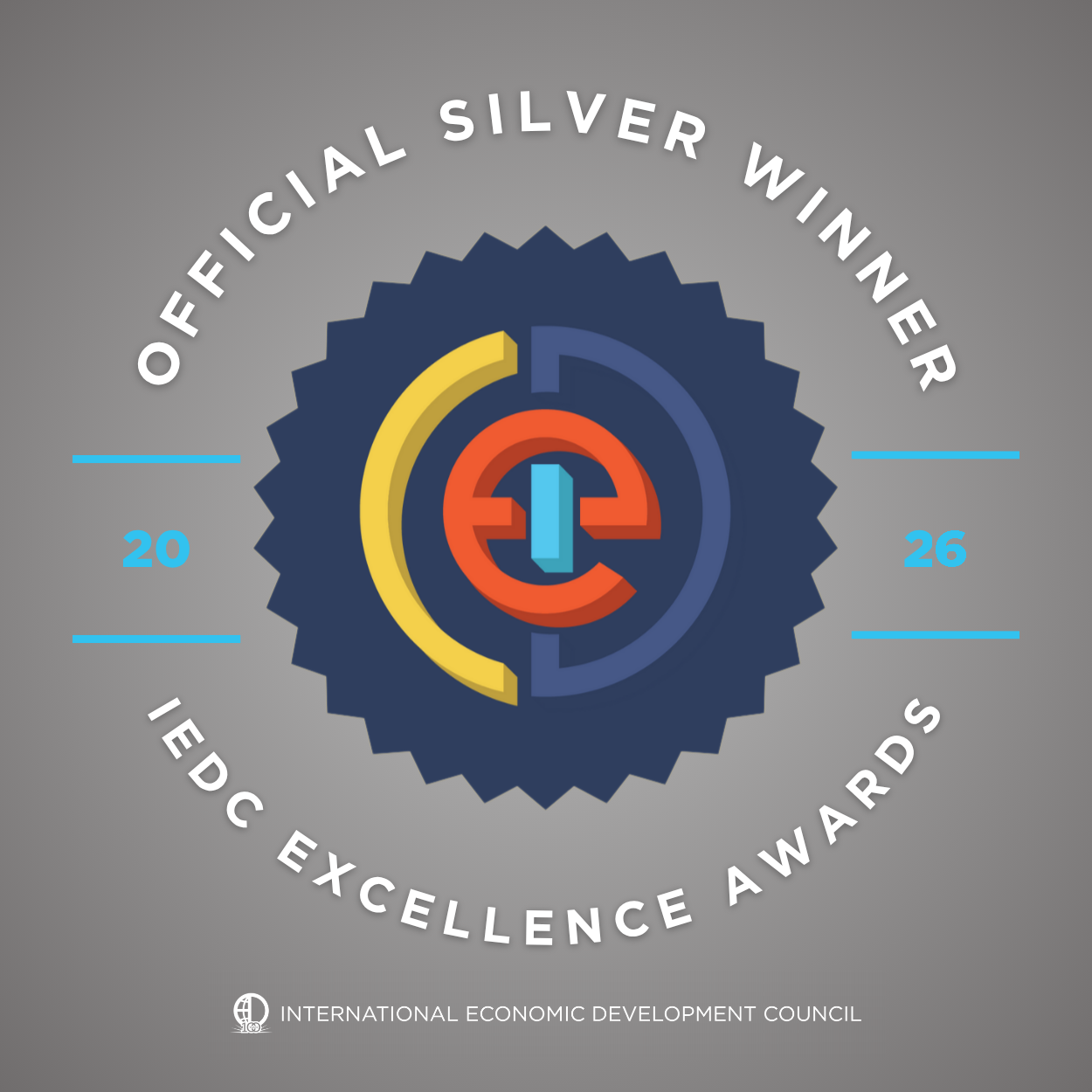 A graphic reads Official Silver Winner IEDC Excellence Awards 2016 in a circle around a stylized logo, with International Economic Development Council at the bottom, celebrating an Alabama electrical services company serving energy and industrial industries in Baldwin County, Bay Minette, AL.
